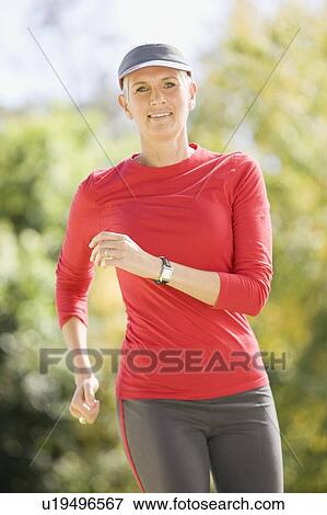 Stock Photo - Smiling woman walking outdoors. Fotosearch