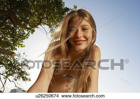 Smiling woman wearing bikini outdoors View Large Photo Image Picture - Smiling woman wearing bikini outdoors. Fotosearch