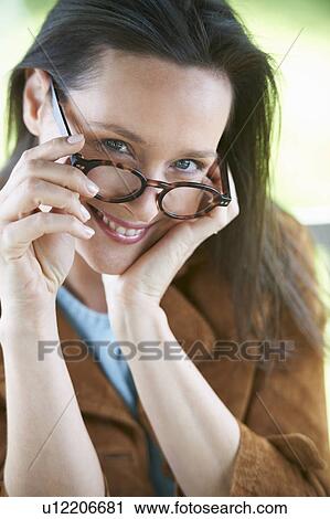 Stock Image - Smiling woman wearing eyeglasses. Fotosearch