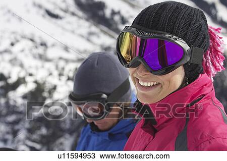 Smiling woman wearing ski goggles View Large Photo Image Stock Image - Smiling woman wearing ski goggles. Fotosearch