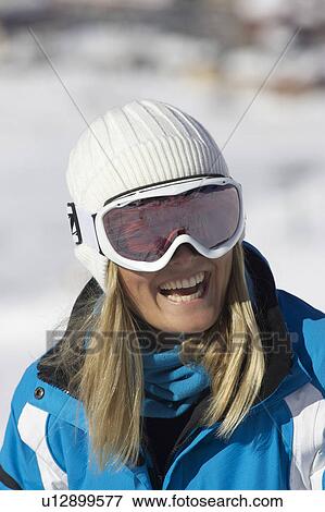 Stock Photo - Smiling woman wearing ski goggles. Fotosearch