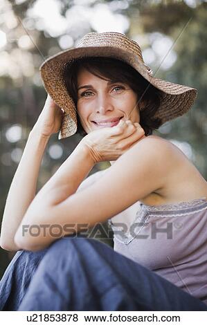 Stock Photo - Smiling woman wearing sunhat. Fotosearch