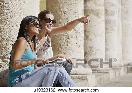 Smiling women sitting on colonnade View Large Photo Image Stock Image - Smiling women sitting on colonnade. Fotosearch