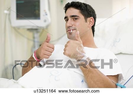 Smoking patient giving ‘thumbs up’ View Large Photo Image Picture - Smoking patient giving ‘thumbs up’. Fotosearch