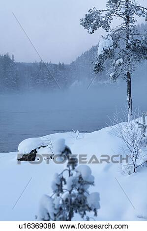 Snow covered field by lake View Large Photo Image Stock Photo - Snow covered field by lake. Fotosearch