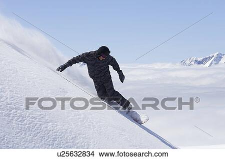 Snowboarder doing tricks on slope View Large Photo Image Picture - Snowboarder doing tricks on slope. Fotosearch