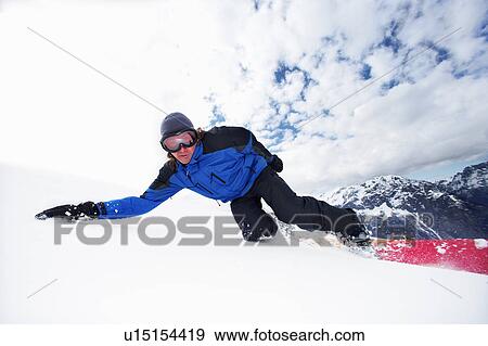 Snowboarder doing tricks on slope View Large Photo Image Stock Photo - Snowboarder doing tricks on slope. Fotosearch
