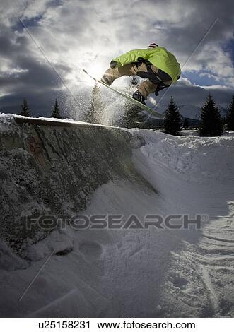 Snowboarder jumping on half-pipe View Large Photo Image Stock Image - Snowboarder jumping on half-pipe. Fotosearch