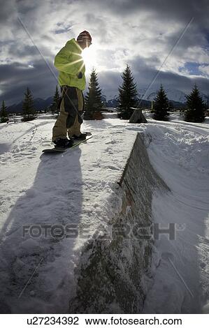 Snowboarder standing on half-pipe View Large Photo Image Stock Image - Snowboarder standing on half-pipe. Fotosearch