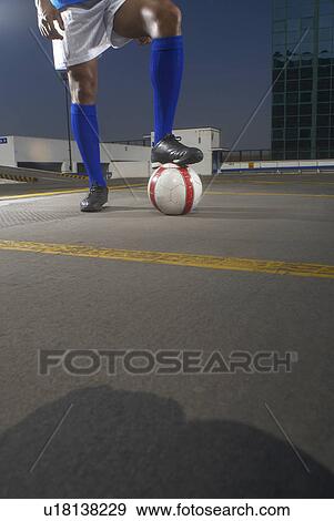 Soccer player with ball on rooftop View Large Photo Image Stock Photo - Soccer player with ball on rooftop. Fotosearch