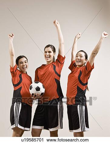 Stock Image - Soccer team cheering together. Fotosearch