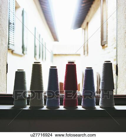 Spools of thread on windowsill View Large Photo Image Picture - Spools of thread on windowsill. Fotosearch