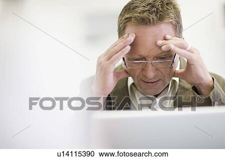 Stressed businessman working in office View Large Photo Image Stock Image - Stressed businessman working in office. Fotosearch