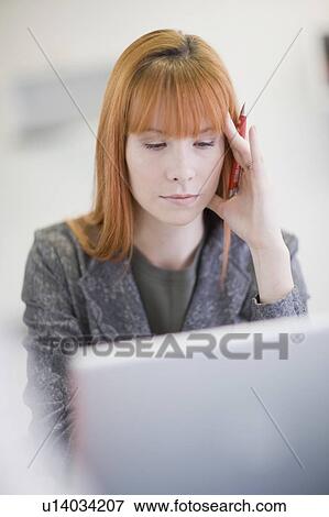 Stock Photo - Stressed businesswoman working in office. Fotosearch