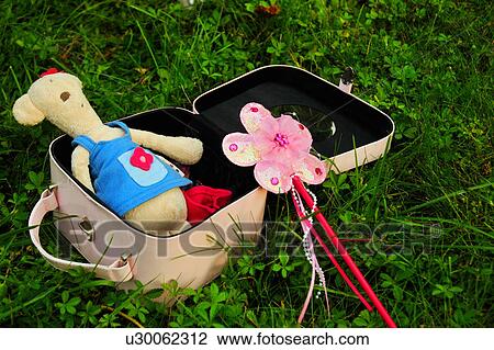Stock Image - Suitcase with teddy bear and wand. Fotosearch