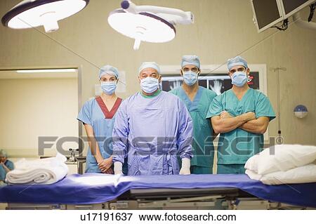Stock Photo - Surgeon and nurses in operating room. Fotosearch