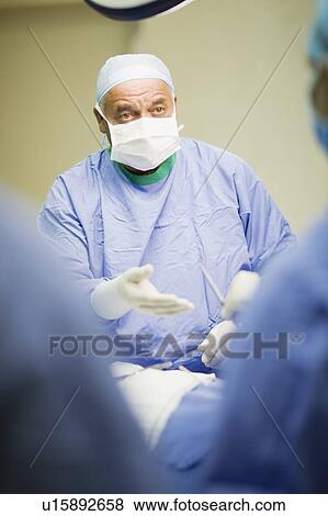Surgeon talking in operating room View Large Photo Image Stock Photo - Surgeon talking in operating room. Fotosearch