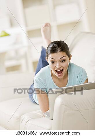 Surprised woman using laptop View Large Photo Image Stock Photo - Surprised woman using laptop. Fotosearch