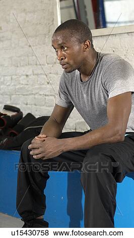 Stock Photo - Sweaty athlete resting in gym. Fotosearch