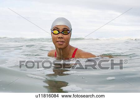 Picture - Swimmer wearing goggles in water. Fotosearch