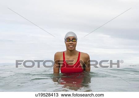 Swimmer wearing goggles in water View Large Photo Image Stock Image - Swimmer wearing goggles in water. Fotosearch
