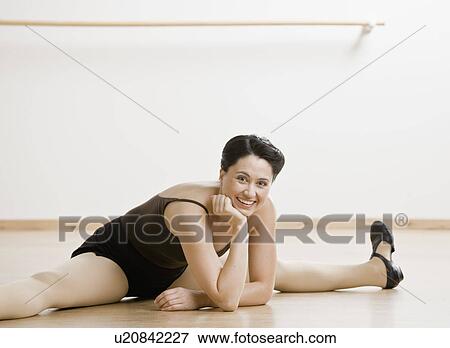 Tap dancer stretching on studio floor View Large Photo Image Stock Photo - Tap dancer stretching on studio floor. Fotosearch