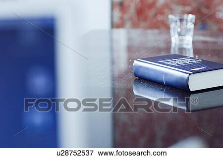 Tax book and glass on office desk View Large Photo Image Stock Photo - Tax book and glass on office desk. Fotosearch