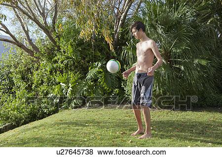 Teenage boy playing with soccer ball View Large Photo Image Stock Photo - Teenage boy playing with soccer ball. Fotosearch