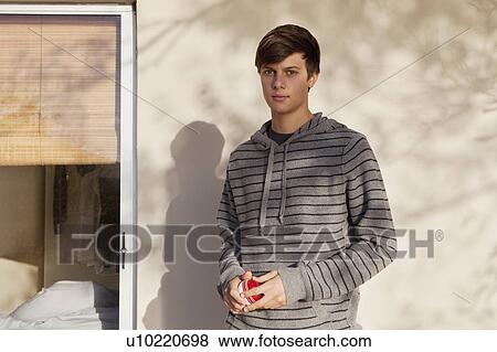Teenage boy standing outdoors View Large Photo Image Stock Photo - Teenage boy standing outdoors. Fotosearch