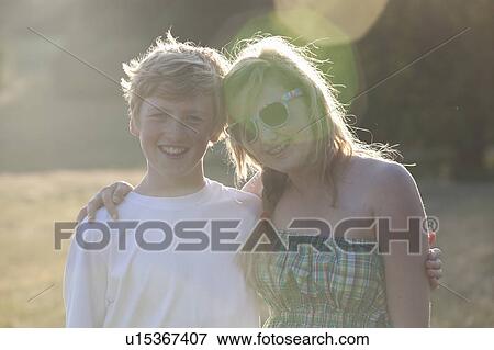Teenage couple standing outdoors View Large Photo Image Stock Photo - Teenage couple standing outdoors. Fotosearch
