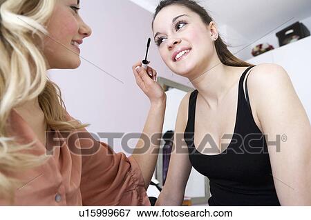 Teenage girls applying makeup View Large Photo Image Stock Photo - Teenage girls applying makeup. Fotosearch