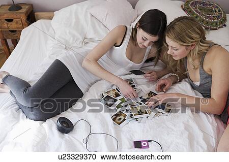 Teenage girls examining polaroids View Large Photo Image Stock Image - Teenage girls examining polaroids. Fotosearch
