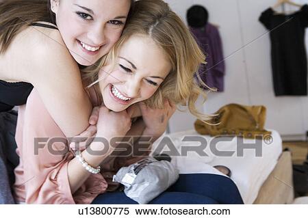 Teenage girls hugging in bedroom View Large Photo Image Stock Photography - Teenage girls hugging in bedroom . Fotosearch