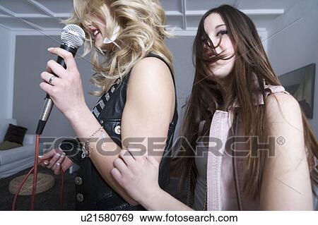 Teenage girls singing karaoke View Large Photo Image Stock Photo - Teenage girls singing karaoke. Fotosearch
