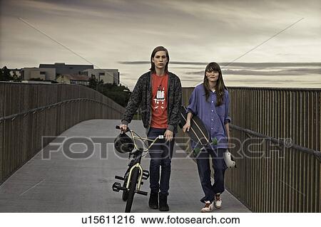 Teenagers with bicycle and skateboard View Large Photo Image Stock Photograph - Teenagers with bicycle and skateboard. Fotosearch