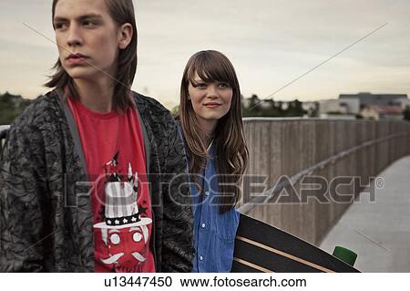 Teenagers with skateboard on walkway View Large Photo Image Stock Image - Teenagers with skateboard on walkway. Fotosearch