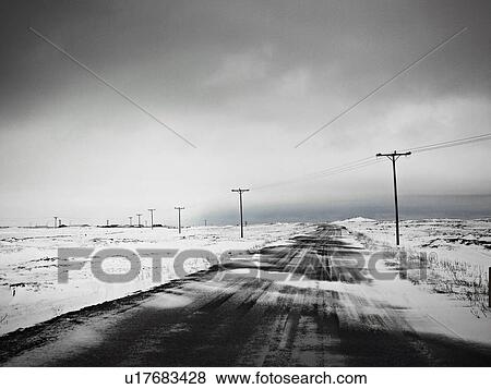 Stock Photo - Telephone poles in snow covered field. Fotosearch