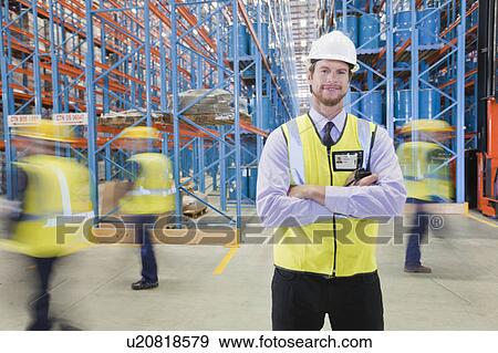 Stock Photo - Time lapse view of workers in warehouse. Fotosearch