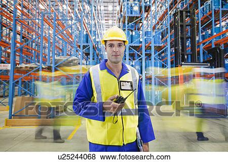 Stock Photo - Time lapse view of workers in warehouse. Fotosearch
