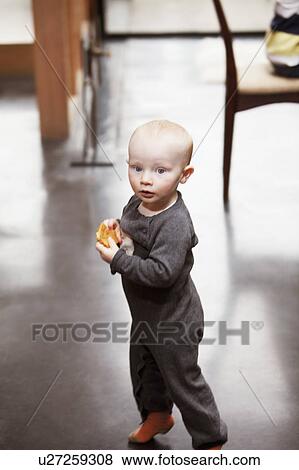 Toddler boy carrying a cookie View Large Photo Image Stock Photo - Toddler boy carrying a cookie. Fotosearch