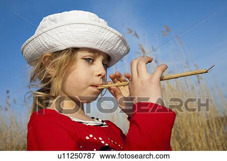 Toddler girl playing in wheat field View Large Photo Image Stock Photo - Toddler girl playing in wheat field. Fotosearch