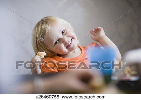 Toddler girl smiling at dinner table View Large Photo Image Stock Photography - Toddler girl smiling at dinner table. Fotosearch