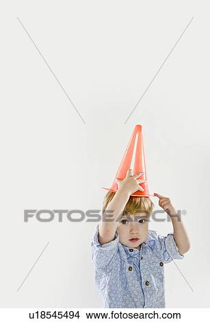 Picture - Toddler playing with traffic cone. Fotosearch