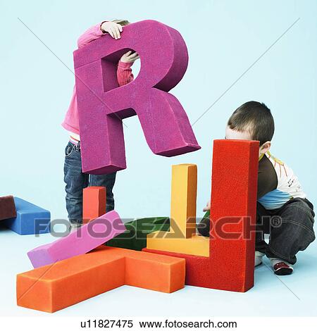 Toddlers playing with oversize letters View Large Photo Image Stock Photography - Toddlers playing with oversize letters. Fotosearch