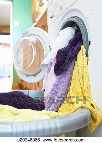 Towels pouring out of dryer View Large Photo Image Stock Photograph - Towels pouring out of dryer. Fotosearch