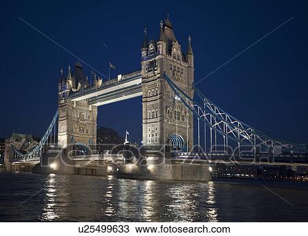 Stock Image - Tower Bridge lit up at night. Fotosearch