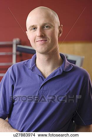 Picture - Trainer smiling in gym. Fotosearch