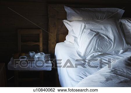 Stock Image - Tray of breakfast food by bed. Fotosearch