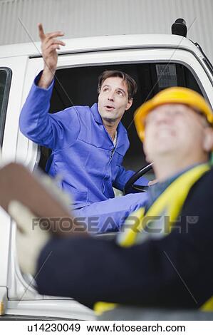 Truck driver talking to worker View Large Photo Image Stock Photo - Truck driver talking to worker. Fotosearch