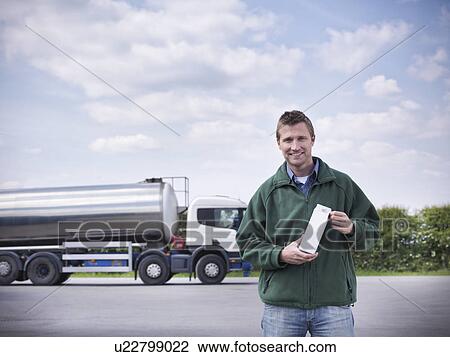 Trucker holding goat's milk by tanker View Large Photo Image Stock Image - Trucker holding goat's milk by tanker. Fotosearch